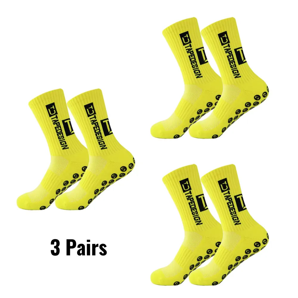 Set of 3 pairs of yellow Tapedesign non-slip socks with '3 pairs' text.
