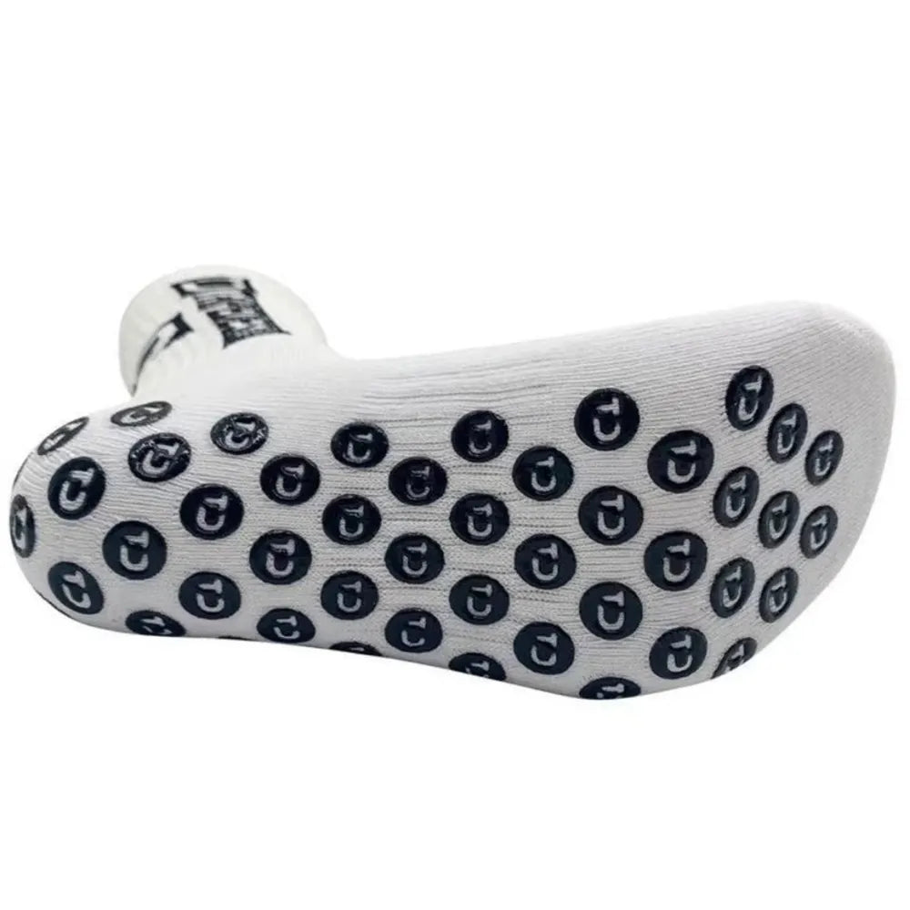 Detailed view of the sole of Tapedesign grip socks, showing all anti-slip points and premium polyester quality.
