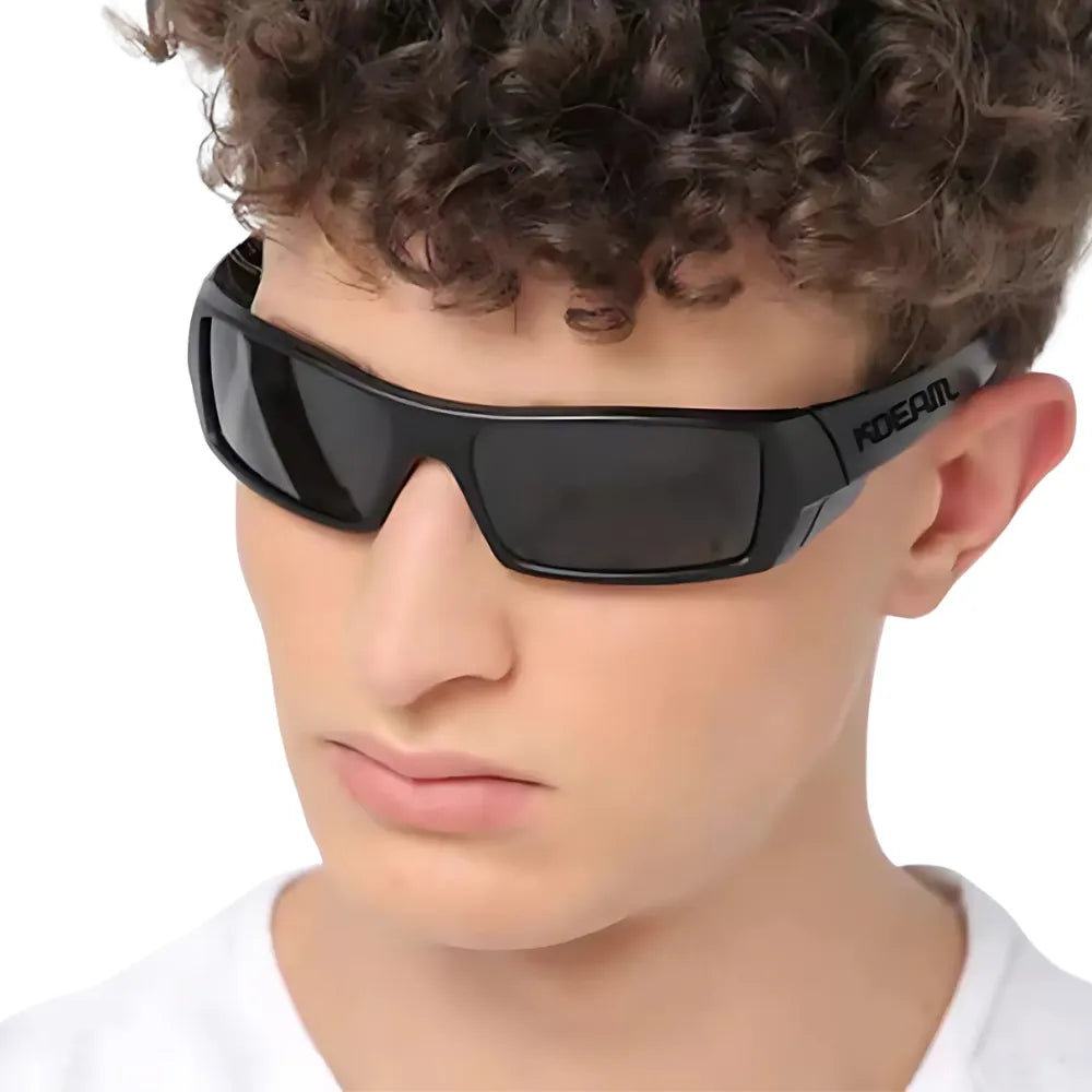 Man wearing KDEAM Havoc black tactical sunglasses, side view showing robust square frame and polarized lenses, looking into the horizon.